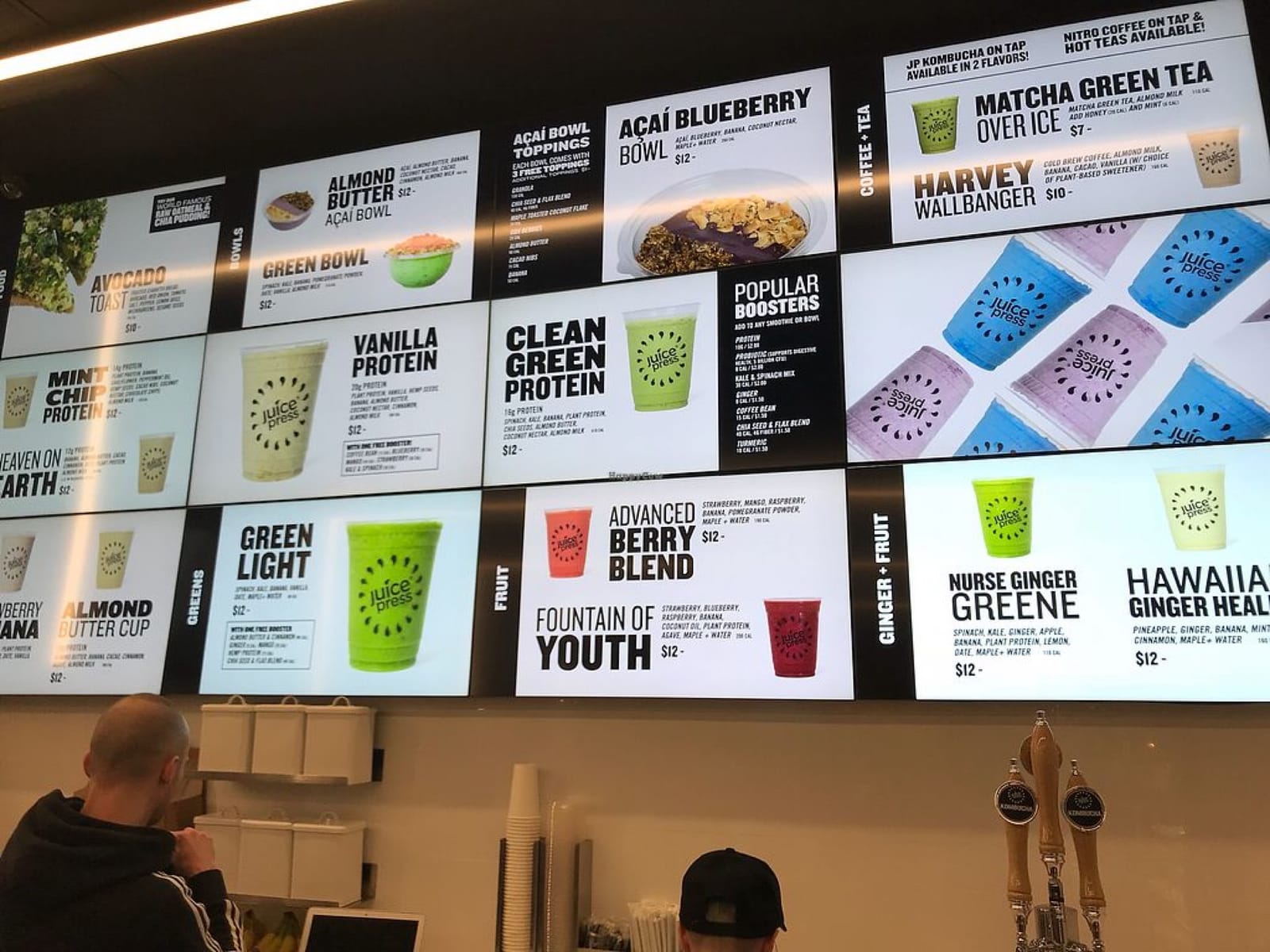 Juice Press counter with wide digital menu board above the service line